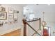 Hallway with stairway, hardwood floors, and decorative lighting fixture near the front door at 3237 Sunset Dr, Charlotte, NC 28209