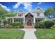 Charming home with a welcoming front yard, featuring lush landscaping and classic architectural details at 3237 Sunset Dr, Charlotte, NC 28209