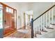 Bright entryway featuring a wooden front door, staircase, and elegant decor at 3237 Sunset Dr, Charlotte, NC 28209