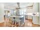 Bright kitchen boasts a spacious island with seating, stainless steel appliances, and white cabinetry at 3237 Sunset Dr, Charlotte, NC 28209