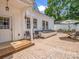 Brick back patio furnished with seating, a table, and an umbrella, accessed by a small porch at 329 E Congress St, Lincolnton, NC 28092