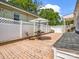 Cozy brick back patio set with a table, umbrella, chair, and a white privacy fence at 329 E Congress St, Lincolnton, NC 28092