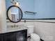 Charming bathroom featuring classic tile, round mirror and pedestal sink at 329 E Congress St, Lincolnton, NC 28092
