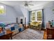 Cozy bedroom with a comfortable quilt, hardwood floors, and plenty of natural light at 329 E Congress St, Lincolnton, NC 28092