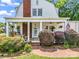 Home featuring covered porch and lush landscaping at 329 E Congress St, Lincolnton, NC 28092