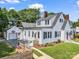 Charming two-story home with white siding, black shutters, an American flag and detached garage at 329 E Congress St, Lincolnton, NC 28092