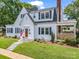 Charming two-story home with white siding, black shutters, an American flag and manicured lawn at 329 E Congress St, Lincolnton, NC 28092