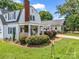 Charming home with a brick chimney, covered porch, and lush landscaping at 329 E Congress St, Lincolnton, NC 28092