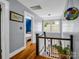 Hallway with hardwood floors leading to a bedroom and staircase with natural light at 329 E Congress St, Lincolnton, NC 28092