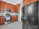 Well-lit kitchen with stainless steel appliances, tile backsplash, granite counters, and wood cabinets at 329 E Congress St, Lincolnton, NC 28092