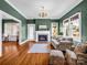 Charming living room featuring a fireplace, chandelier, and hardwood floors, perfect for entertaining or relaxing at 329 E Congress St, Lincolnton, NC 28092