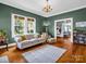 Cozy living room with large windows, chandelier, hardwood floors and multiple rooms for a spacious feel at 329 E Congress St, Lincolnton, NC 28092