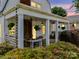 Inviting covered porch with hanging plants, a porch swing, and brick pillars at 329 E Congress St, Lincolnton, NC 28092