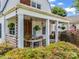 Inviting covered porch with hanging plants, a porch swing, and brick pillars at 329 E Congress St, Lincolnton, NC 28092