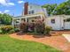 Charming home featuring a side porch framed by a brick pathway and well-maintained shrubs at 329 E Congress St, Lincolnton, NC 28092