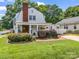 Charming home featuring a brick pathway leading to a side porch, accented by manicured bushes at 329 E Congress St, Lincolnton, NC 28092