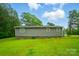 Gray house exterior showcasing a vast lawn and surrounded by trees at 3810 Biggers Rd, York, SC 29745