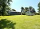 Backyard view of single-Gathering home with storage shed on an expansive green lawn at 3810 Biggers Rd, York, SC 29745