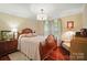 Main bedroom with a wooden bed frame, hardwood floors, and natural light at 3810 Biggers Rd, York, SC 29745