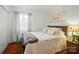 Bedroom features wood floors, a queen-sized bed, and bright, sheer curtains at 3810 Biggers Rd, York, SC 29745