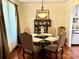 Elegant dining room with a glass-top table, four chairs, and a decorative hutch at 3810 Biggers Rd, York, SC 29745