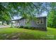 Low angle view of home, showcasing the manicured lawn and mature trees that surround the cozy, single-story house at 3810 Biggers Rd, York, SC 29745