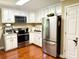 Modern kitchen with stainless steel appliances, white cabinets, and solid surface countertops at 3810 Biggers Rd, York, SC 29745