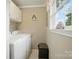 Laundry room including washer, dryer, overhead cabinet, and window at 3810 Biggers Rd, York, SC 29745