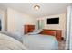 Cozy bedroom with wood furniture, carpeted floors, and a mounted television at 39 Selma Dr, Mooresville, NC 28115