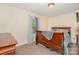 Bedroom with wood furniture, neutral walls, decorative window treatments and carpeted flooring at 39 Selma Dr, Mooresville, NC 28115