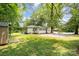 Charming single-story home nestled among mature trees and features a lush, green lawn at 39 Selma Dr, Mooresville, NC 28115