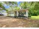 Charming single-story home featuring a cozy front porch and light yellow siding at 39 Selma Dr, Mooresville, NC 28115