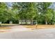 Charming light yellow home with a covered porch and mature shade trees at 39 Selma Dr, Mooresville, NC 28115