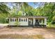 Charming single-story home featuring a cozy front porch and light yellow siding at 39 Selma Dr, Mooresville, NC 28115