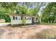 Charming light yellow home with a covered porch and mature shade trees at 39 Selma Dr, Mooresville, NC 28115