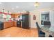 Eat-in kitchen with wood cabinets, black appliances, decorative curtains and wall hangings at 39 Selma Dr, Mooresville, NC 28115