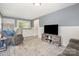 Inviting living room with included washer and dryer, comfortable seating, and modern entertainment center at 39 Selma Dr, Mooresville, NC 28115
