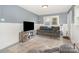 Inviting living room boasts modern flooring, neutral paint, cozy sofa and stylish entertainment center at 39 Selma Dr, Mooresville, NC 28115