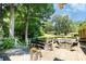 Inviting backyard deck with outdoor seating, grill, and mature trees at 400 S Westover Dr, Monroe, NC 28112
