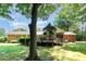 Lush backyard with a gazebo, deck, mature trees, and well-maintained lawn at 400 S Westover Dr, Monroe, NC 28112