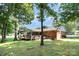 Expansive backyard features a deck, gazebo, screened porch, and mature trees at 400 S Westover Dr, Monroe, NC 28112