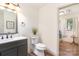 Neutral toned bathroom boasts modern vanity, toilet, and ample natural light at 400 S Westover Dr, Monroe, NC 28112