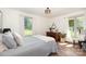 Sunlit bedroom with wood floors, large windows, and neutral-colored walls at 400 S Westover Dr, Monroe, NC 28112