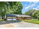 Well-maintained brick home with lush lawn, an attached two-car garage, and a concrete driveway at 400 S Westover Dr, Monroe, NC 28112