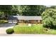 Well-maintained brick home featuring lush lawn, an attached two-car garage, and mature trees at 400 S Westover Dr, Monroe, NC 28112