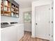 Bright laundry area featuring a washer and dryer with cabinets above, and access to the exterior at 400 S Westover Dr, Monroe, NC 28112