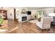 Spacious living room with a white brick fireplace, hardwood floors, and plenty of natural light at 400 S Westover Dr, Monroe, NC 28112