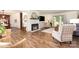 Spacious living room with a white brick fireplace, hardwood floors, and plenty of natural light at 400 S Westover Dr, Monroe, NC 28112