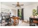 Bright office featuring a ceiling fan, desk, and built-in shelving for displaying books and collectables at 400 S Westover Dr, Monroe, NC 28112
