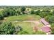 Expansive aerial view of property featuring a residence and lush surrounding landscape with mature trees at 4026 Biggerstaff Rd, Maiden, NC 28650